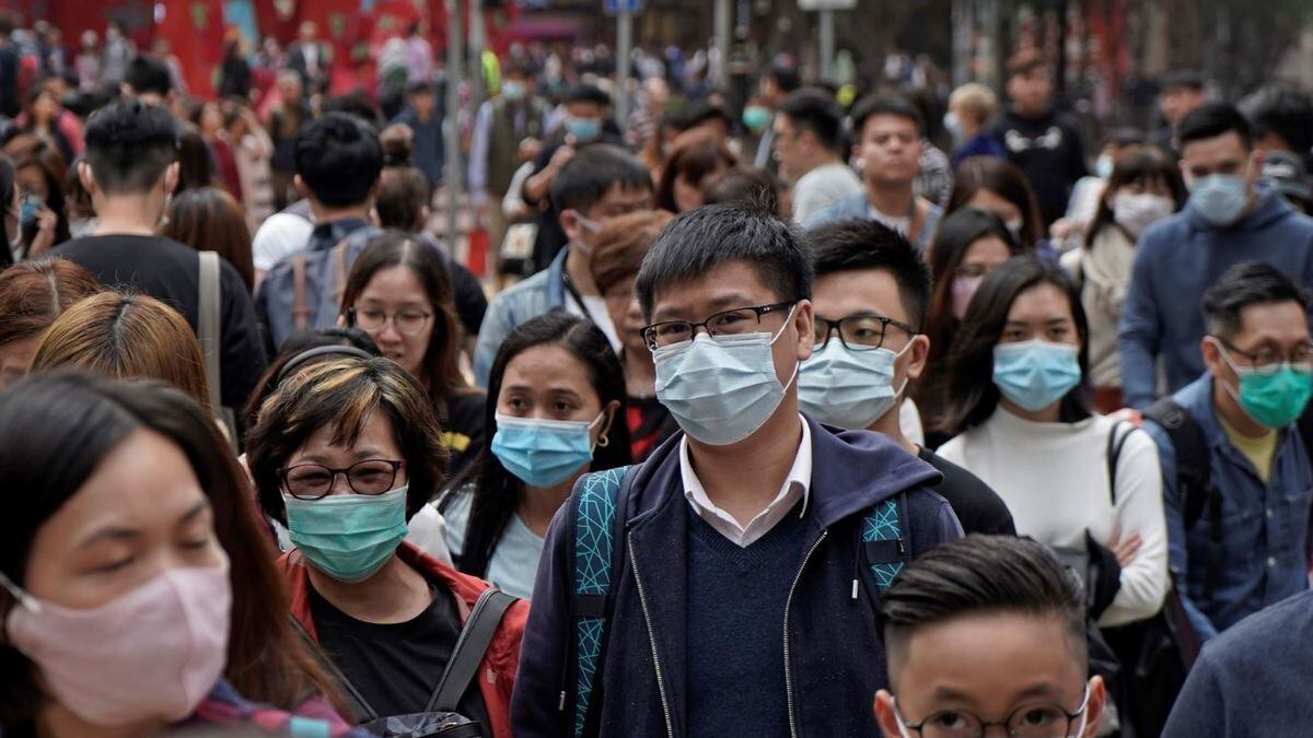 People wear masks on a street in Hong Kong, Friday, Jan. 24, 2020 to celebrate the Lunar New...