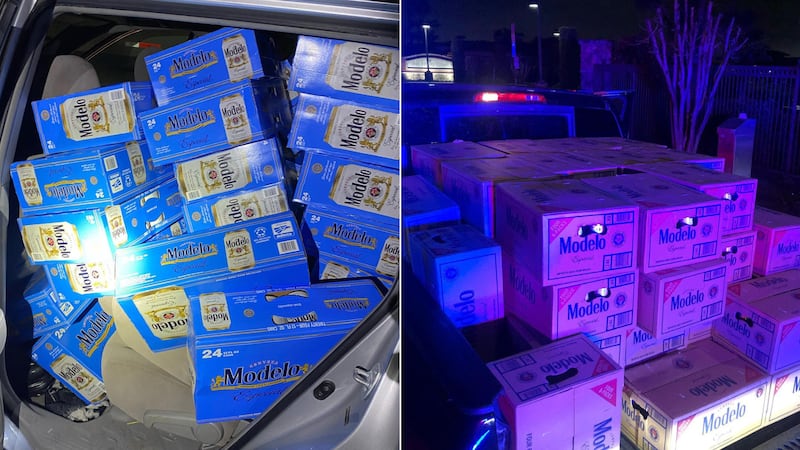 Cases of Modelo can be seen stacked in the back of a pickup and inside two other vehicles.
