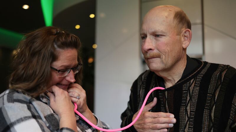 Amber Morgan, from South Bend, Ind., listens to the heartbeat of Tom Johnson, from Kankakee,...