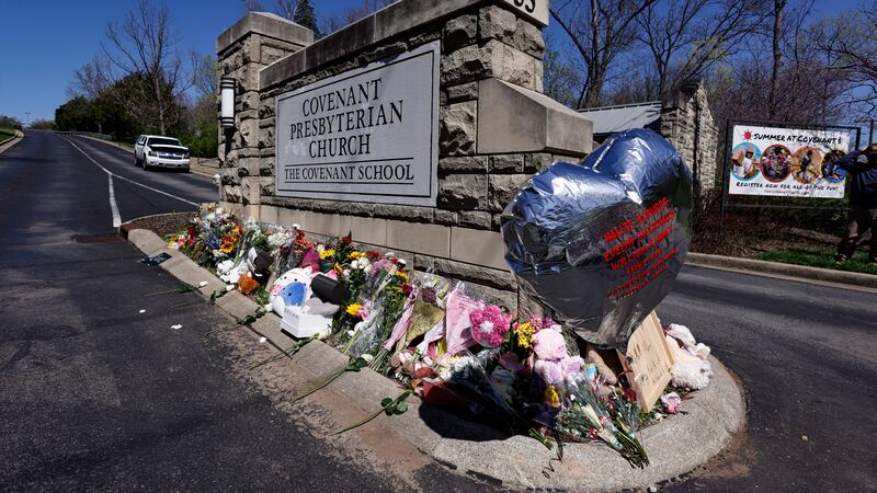 A balloon with names of the victims is seen at a memorial at the entrance to The Covenant...