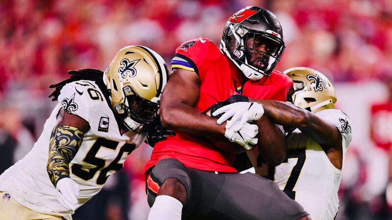 Demario Davis and Malcolm Jenkins team up to tackle Leonard Fournette. (Source: Michael Nance)