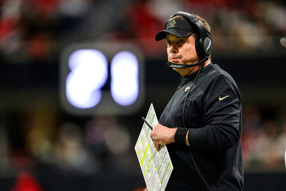 New Orleans Saints head coach Sean Payton works during the first half of an NFL football game...