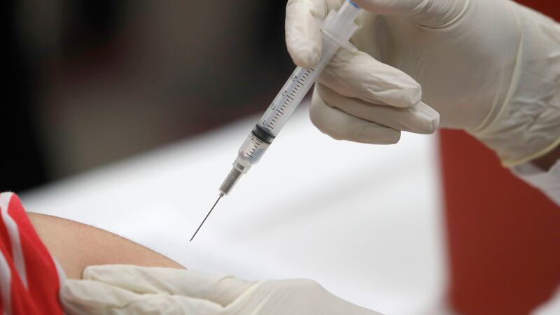 In this Thursday, Jan. 23, 2020 file photo, a patient receives an influenza vaccine.