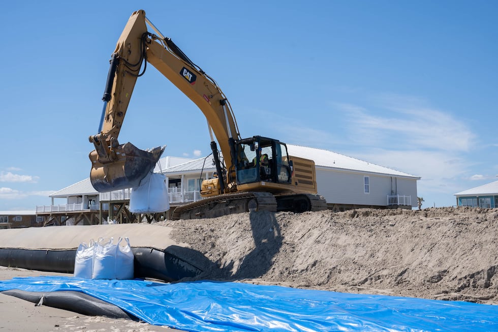Louisiana National Guardsmen assigned to the 225th Engineer Brigade emplace 3-by-3 foot sacks...