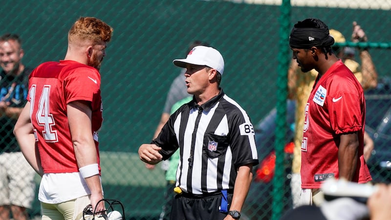 Referee Shawn Hochuli (83) talks to New Orleans Saints' Jameis Winston and Andy Dalton before...