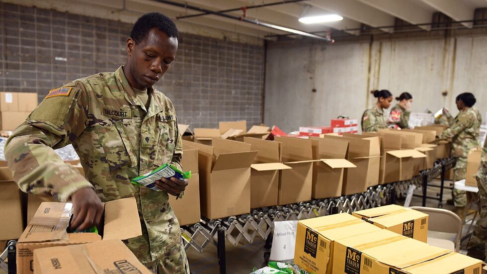Louisiana Army Guard Soldiers pack non-perishable food boxes for the Greater Baton Rouge Food...