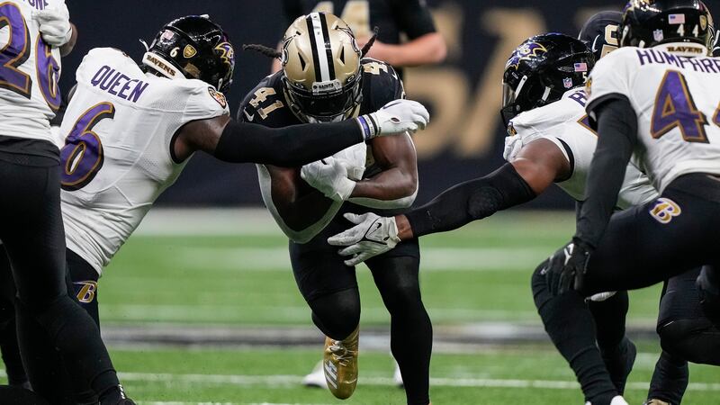 Saints running back Alvin Kamara (41) is tackled by Baltimore Ravens linebacker Patrick Queen...