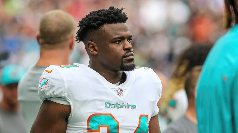 Miami Dolphins running back Malcolm Brown (34) walks the sideline before an NFL football game...