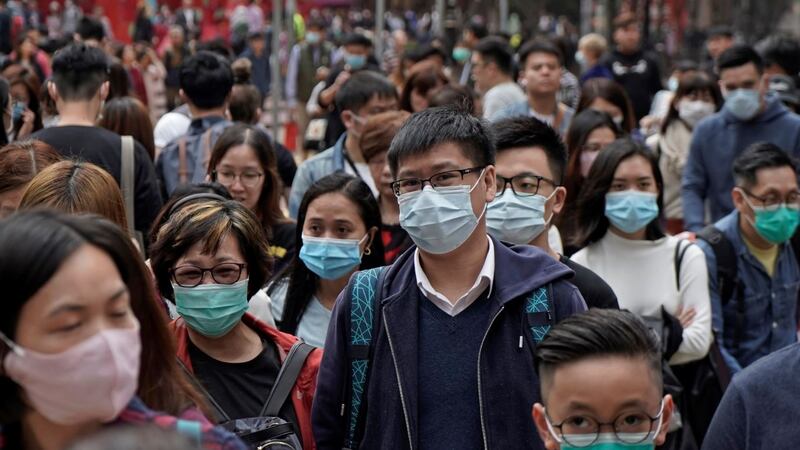 People wear masks on a street in Hong Kong, Friday, Jan. 24, 2020 to celebrate the Lunar New...