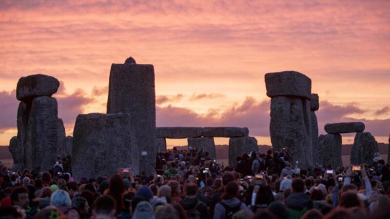 In this Sunday, June 21, 2015 file photo, the sun rises as thousands of revelers gather at the...